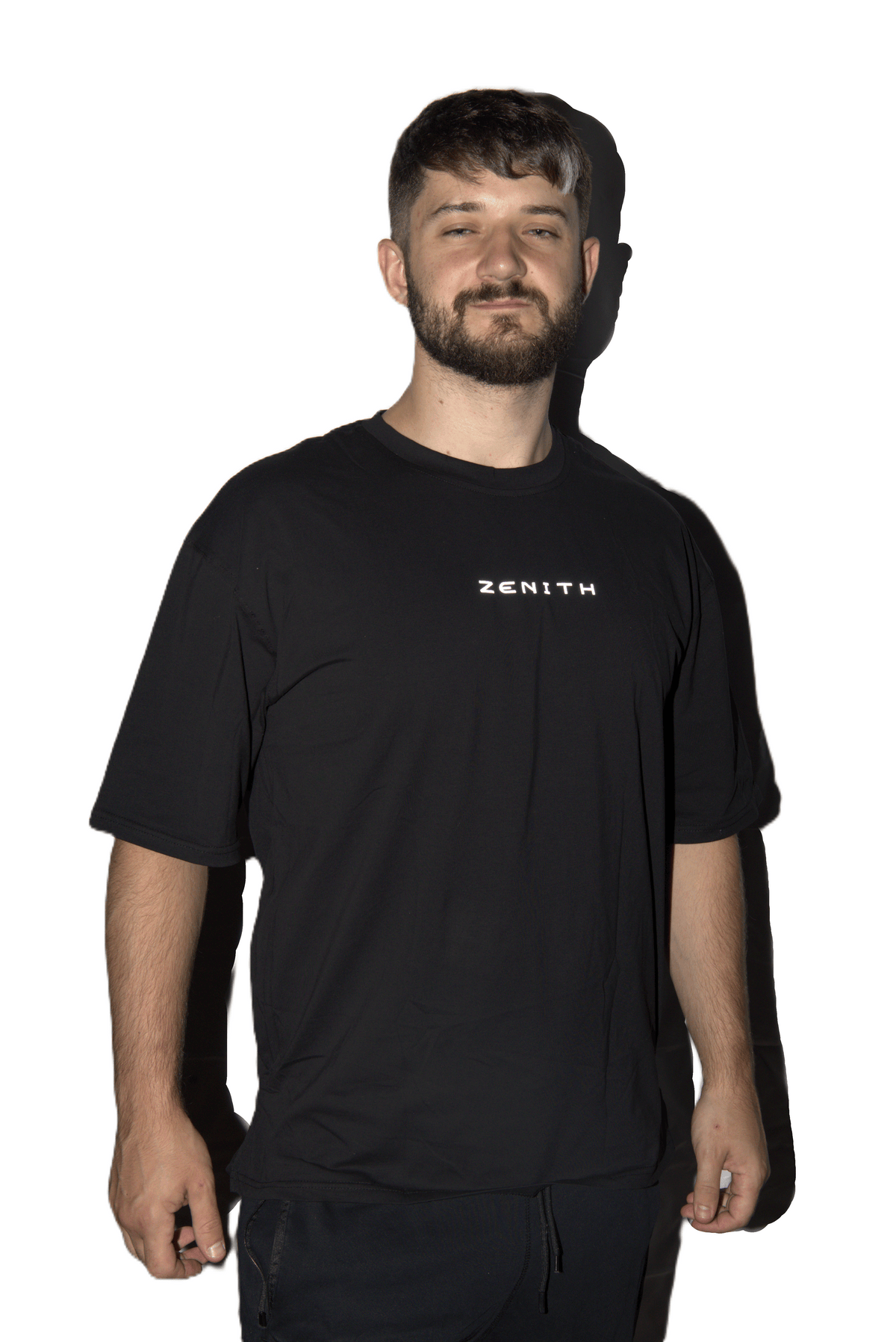 A man wearing a black short-sleeve t-shirt with the brand name 'ZENITH' printed in white on the chest, set against a plain white background.