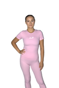 A woman modeling a light pink athletic t-shirt and matching leggings set with a white script logo on the chest, set against a plain white background.