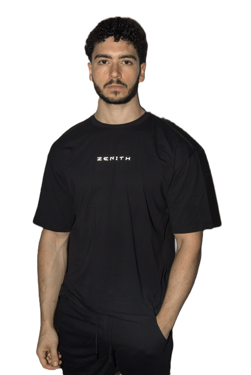 A man wearing a black short-sleeve t-shirt with the brand name 'ZENITH' printed in white on the chest, set against a plain white background.